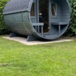 Barrel garden sauna 280 with front porch installed outdoors