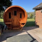 Front view of wooden barrel garden sauna 280 installed outdoors