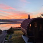 Barrel garden sauna 280 installed by lake at sunset