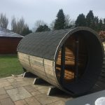 Front exterior view of barrel garden sauna 330 with balcony installed outdoors