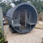 Barrel garden sauna front porch interior with bench seating