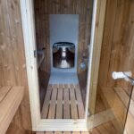 Front interior view of barrel sauna 330 with wood-fired heater