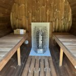 Electric sauna heater inside barrel sauna 330 with balcony
