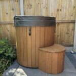 Cold Tub 100 fiberglass ice bath installed in backyard with wooden cladding