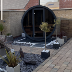 Terrace Sauna 160 with full moon glass front installed on outdoor terrace